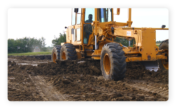 H. Ray & Sons Grader leveling a pad for housing